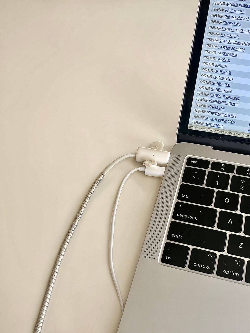 Laptop charging cable connections on a desk