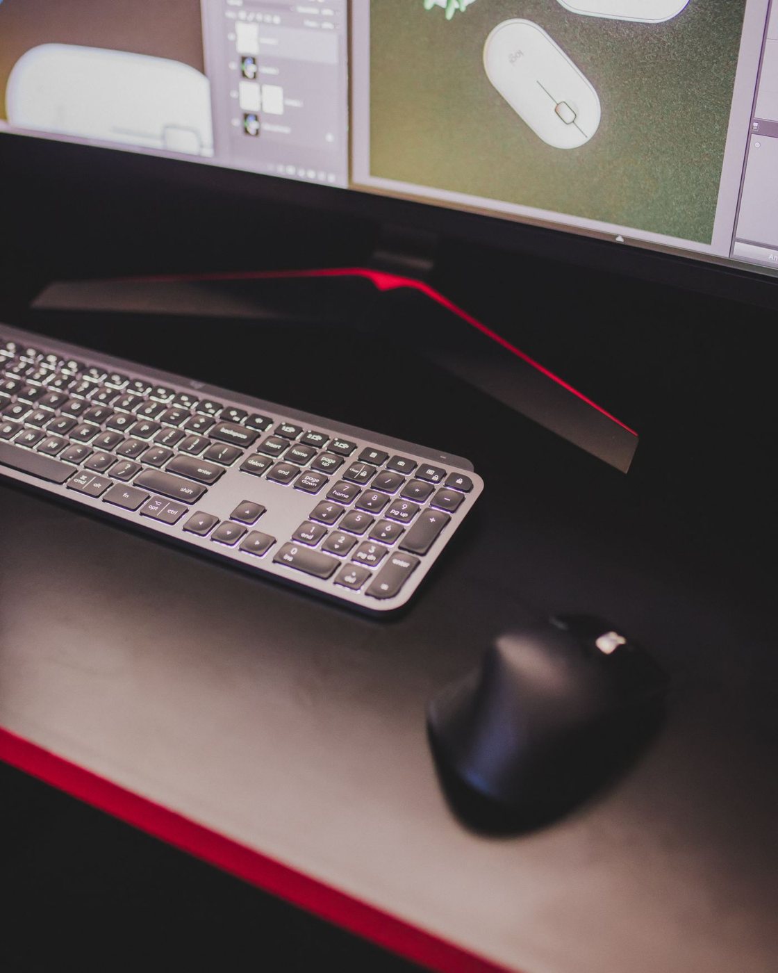 Keyboard and mouse on a wide desktop mat