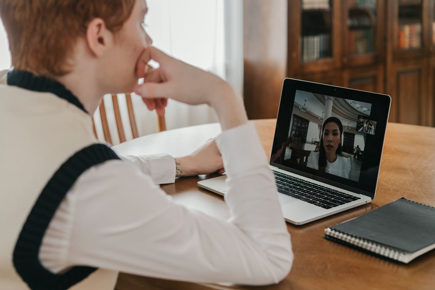 Person attending an online meeting on a laptop