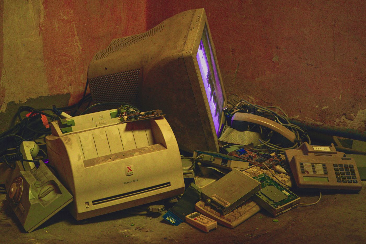 Old monitors, a printer, and other discarded electronic equipment