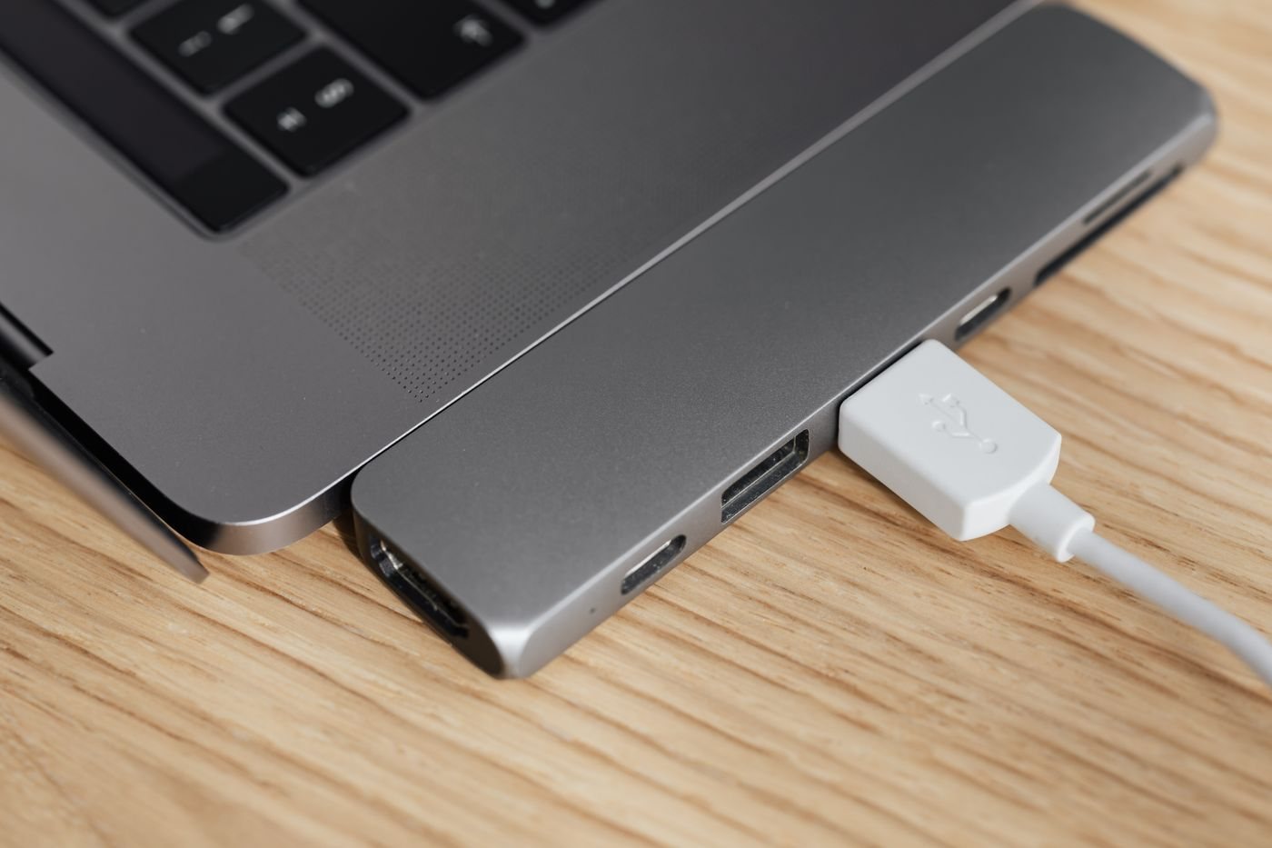 USB-C multiport adapter connected beside a laptop
