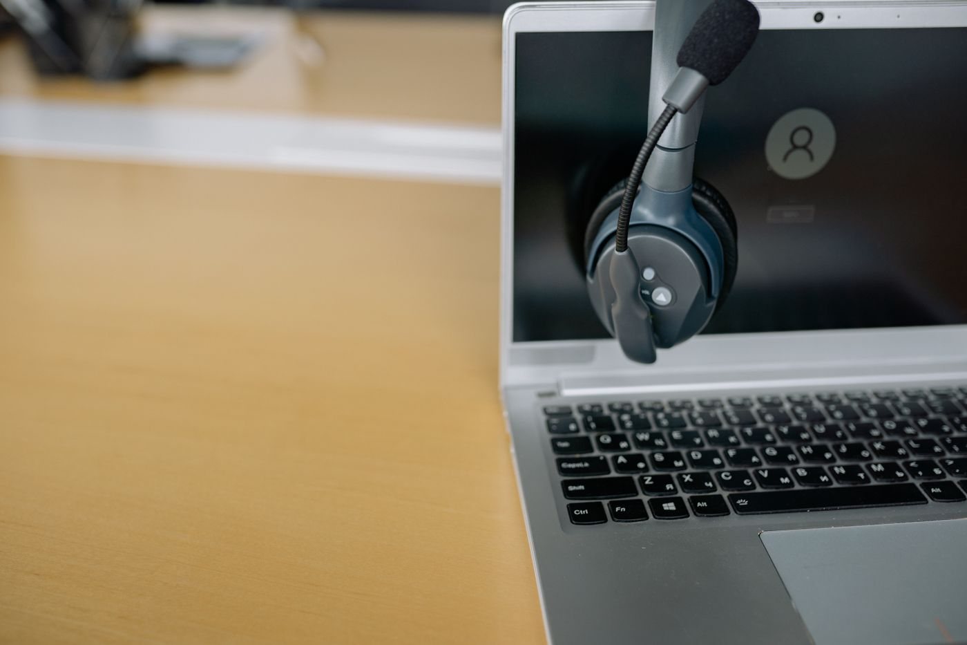 Communication headset placed on a laptop