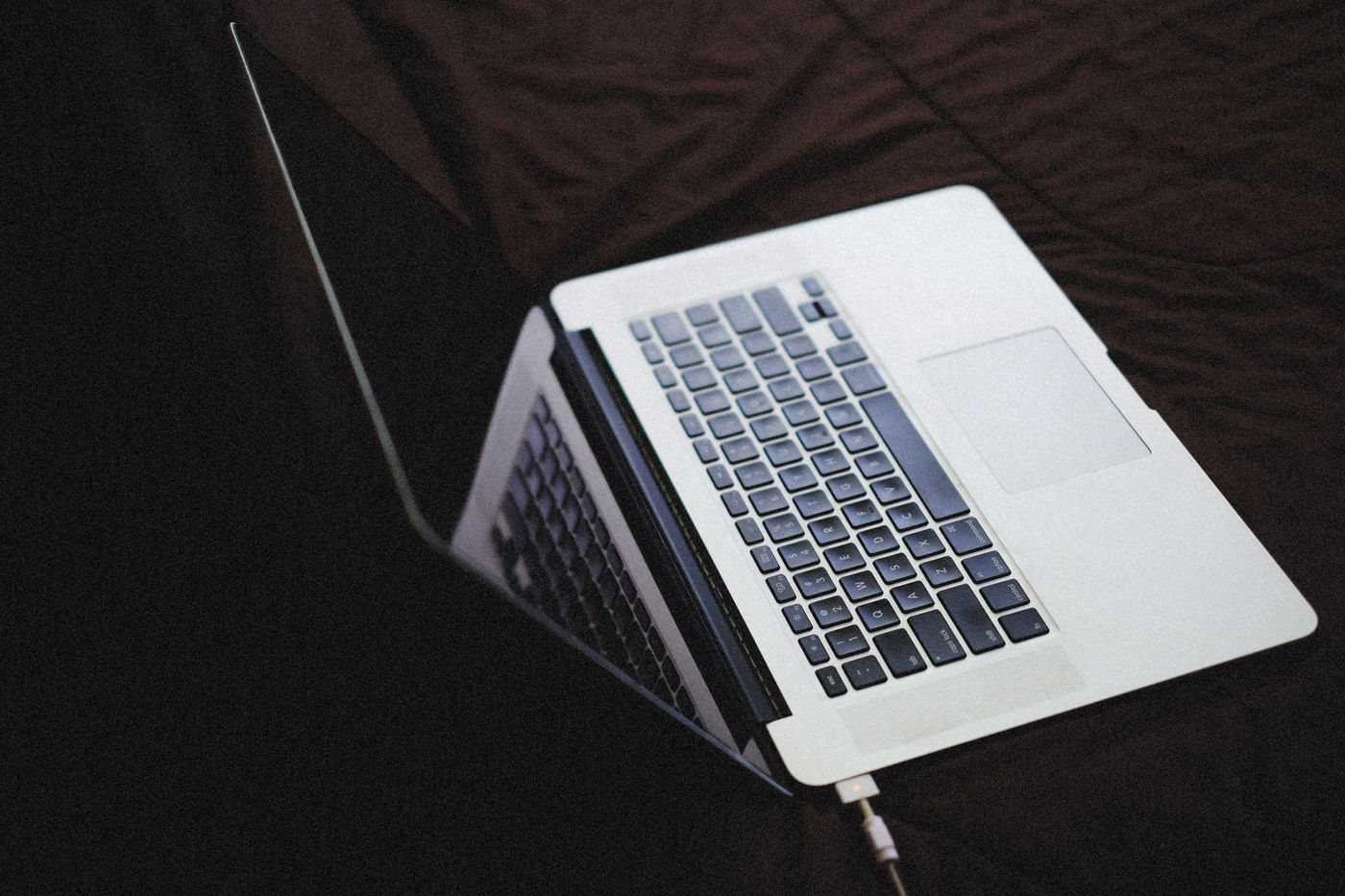 Laptop connected to its charging cable