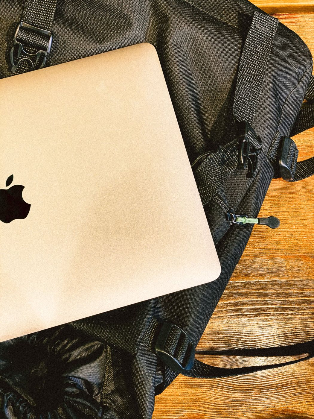 Laptop resting on a travel backpack