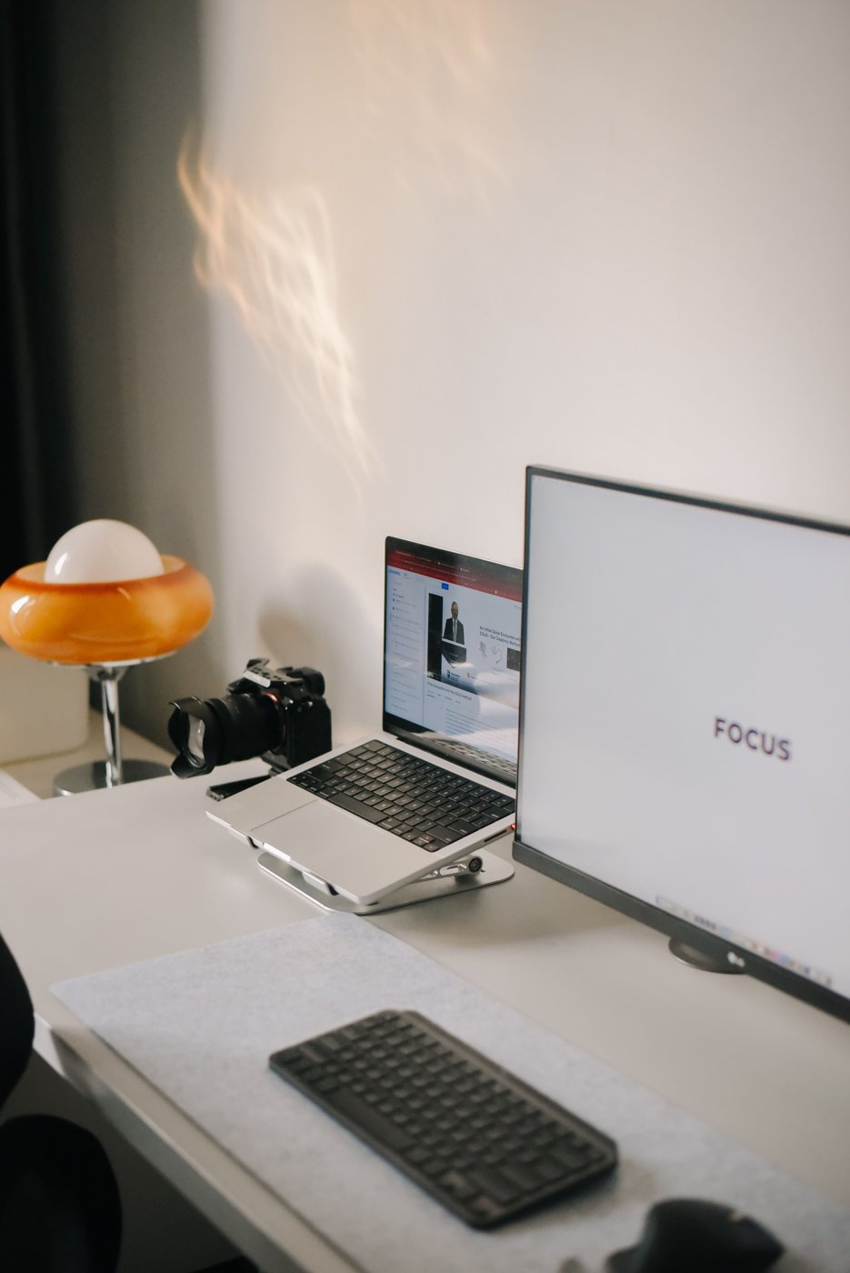A monitor and laptop arranged on a home office desk