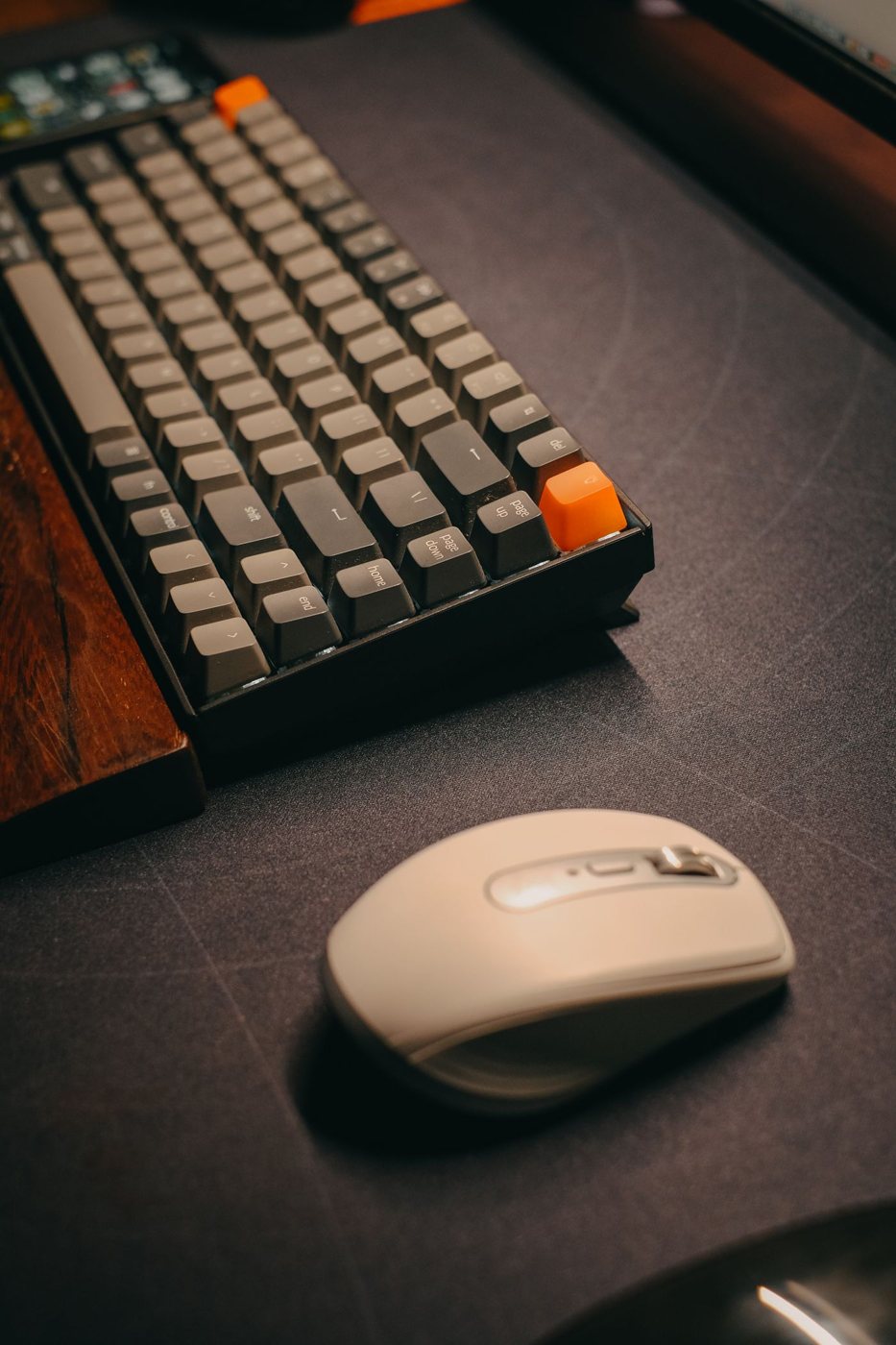Mouse beside a keyboard on a desk surface