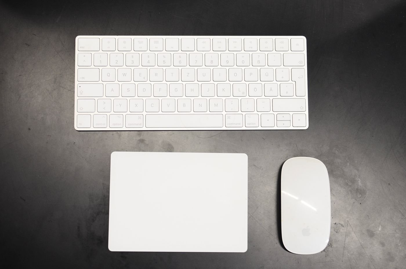 Low-profile keyboard and mouse on a dark desk
