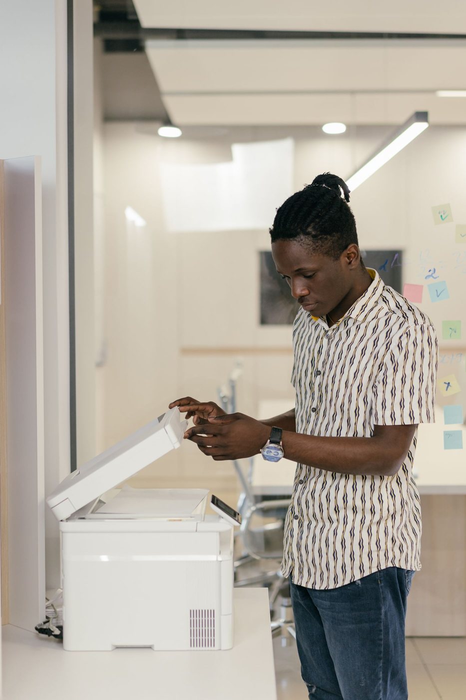 Person scanning documents with an office copier
