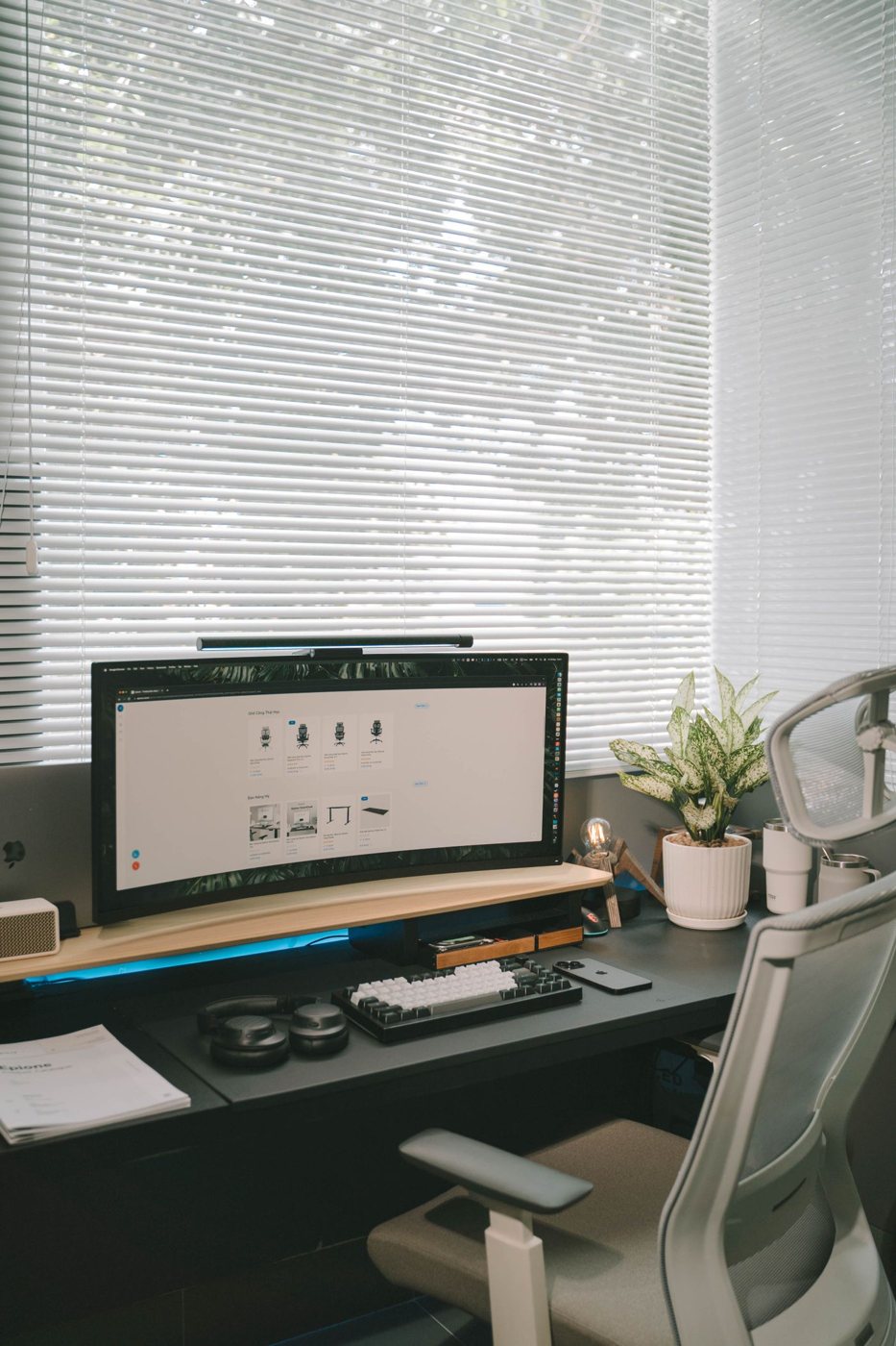 Computer desk positioned beside a window