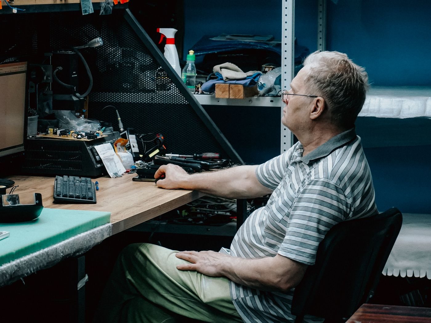 Person inspecting a computer at a workbench