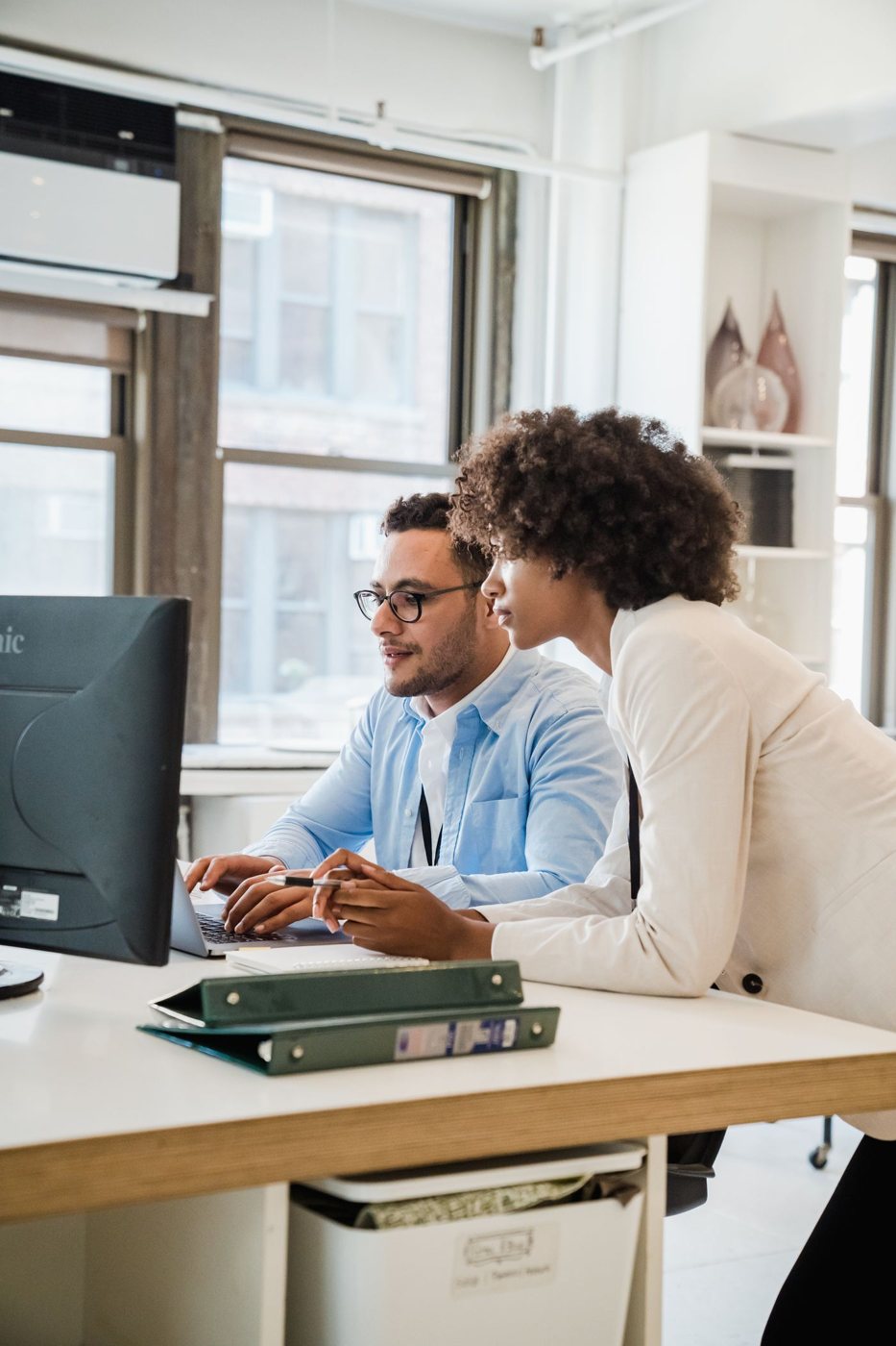 Two people working together at an office desk