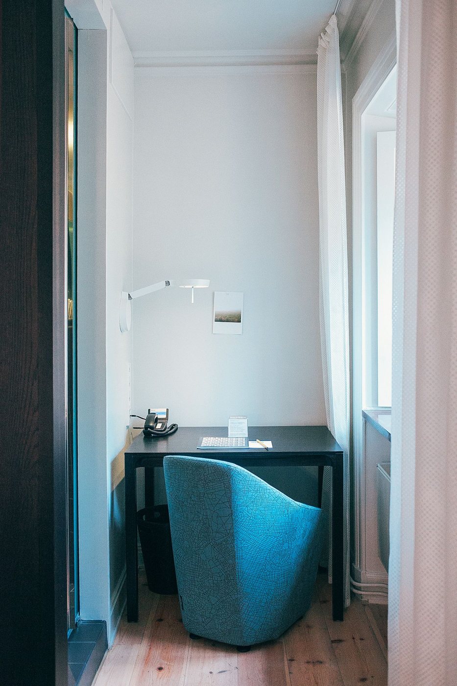 Compact desk and chair beside a window