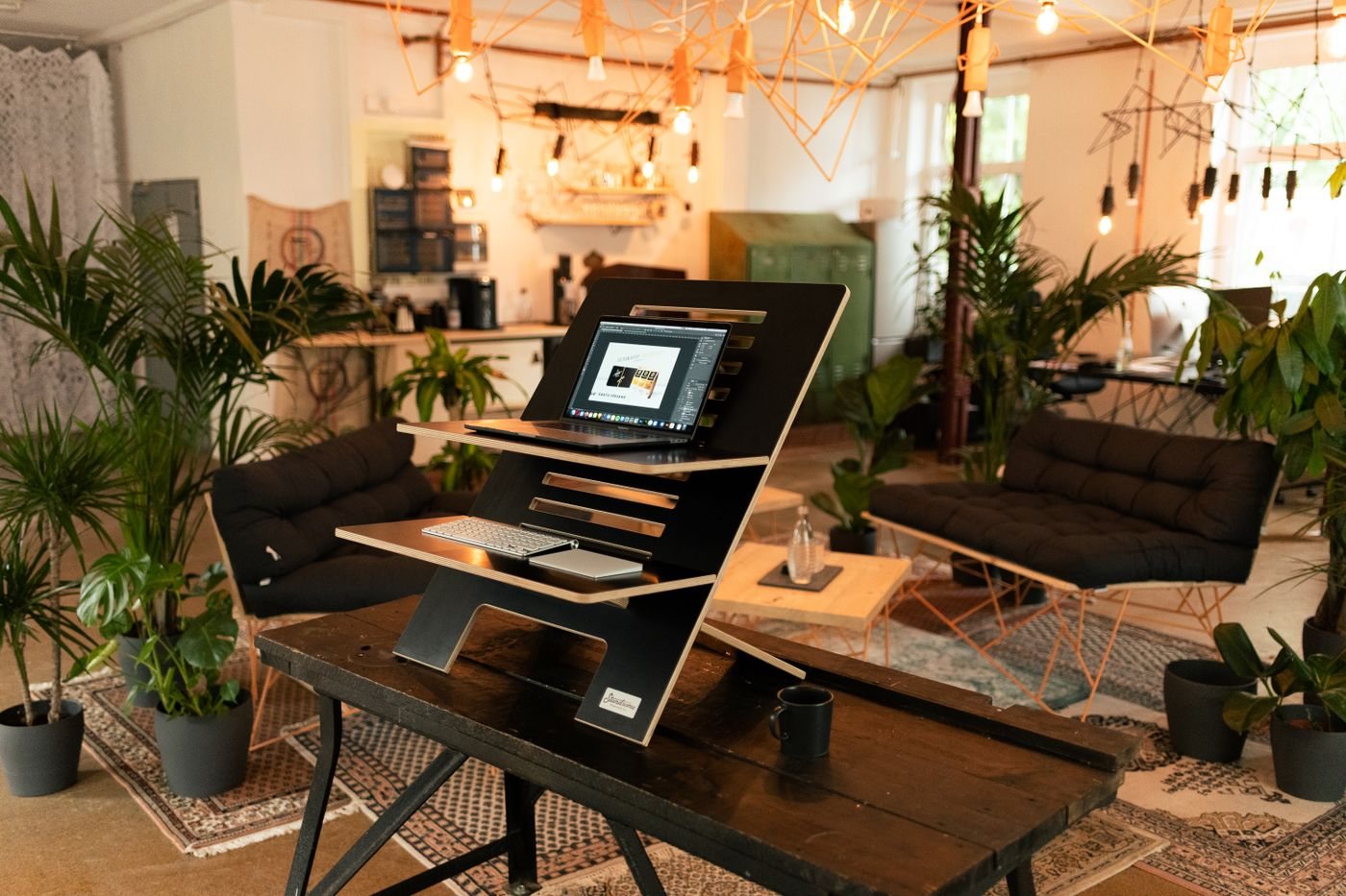 Laptop elevated on a standing desk converter