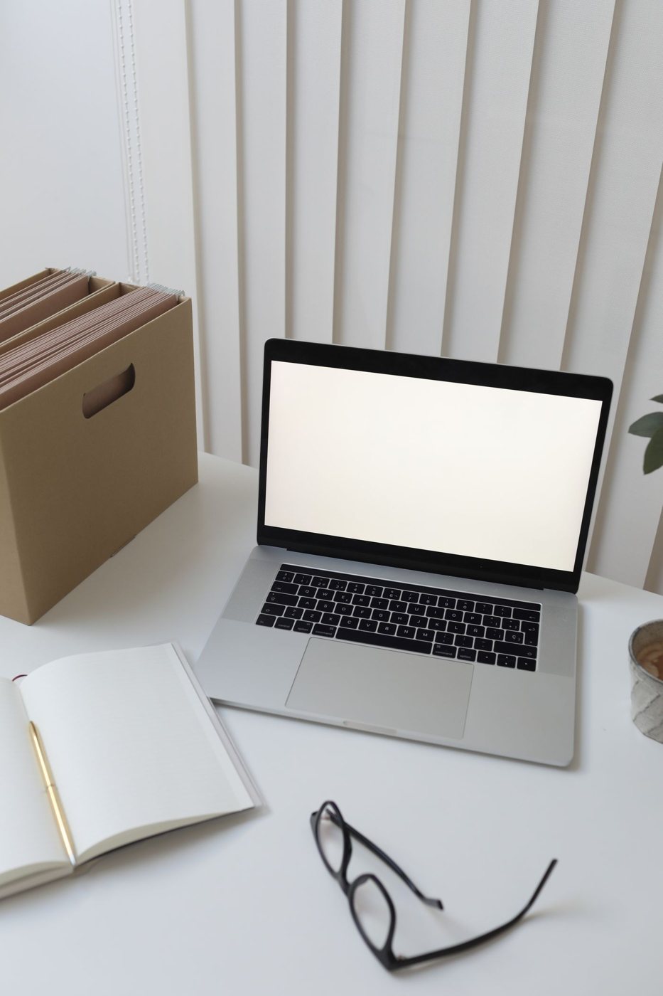 Laptop and organized paper notes on a desk