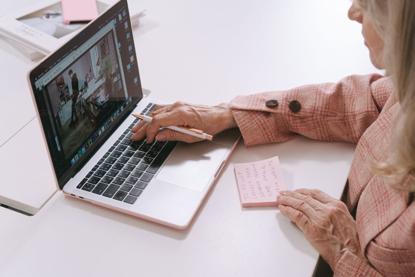 Person using a laptop with planning notes
