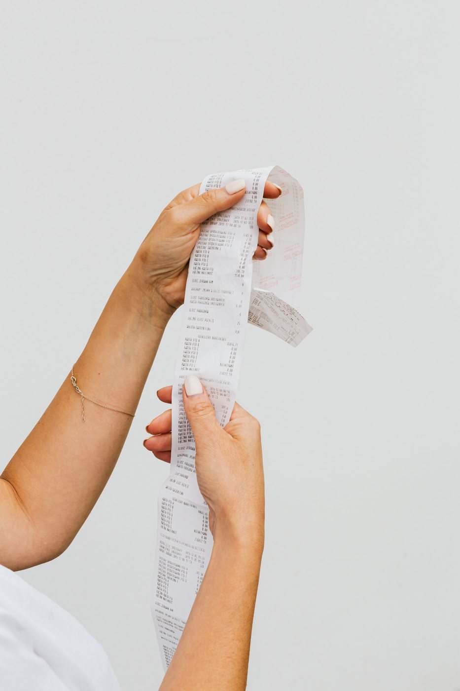 Hands holding a purchase receipt