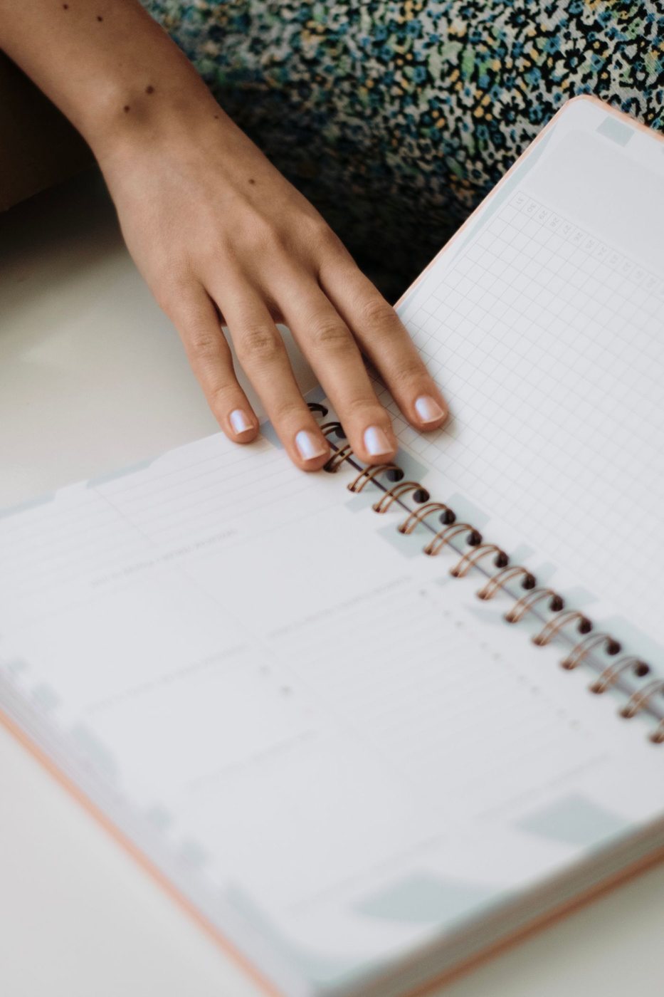 Hand resting on an open planner